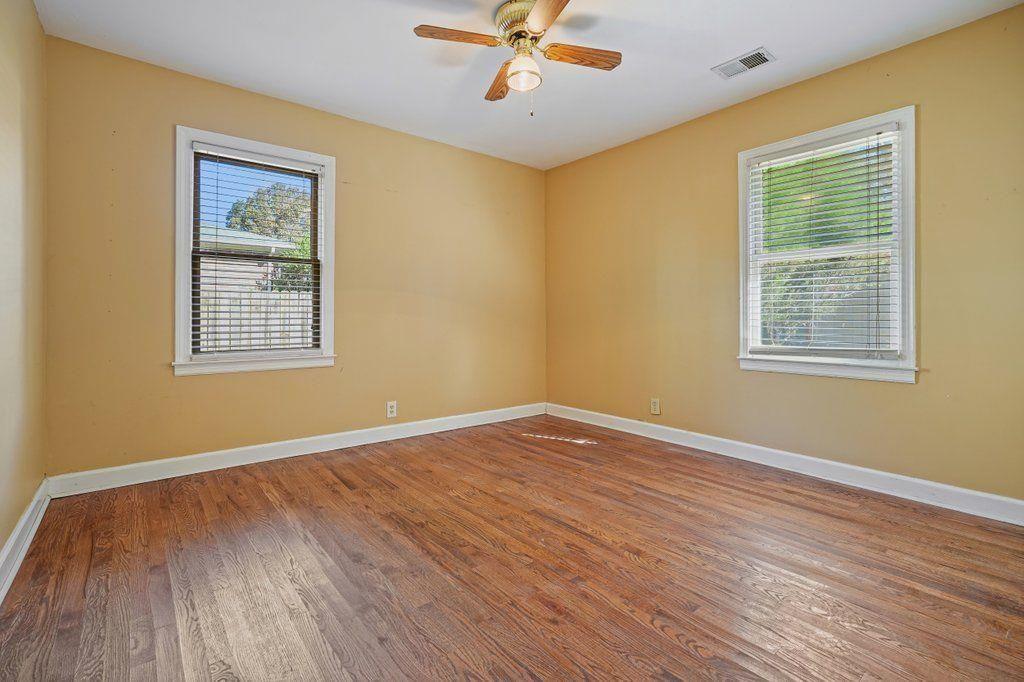 3799 Oglesby Road Powder Springs, GA 30127 - Photo 22 of 39 a view of an empty room with wooden floor and a window