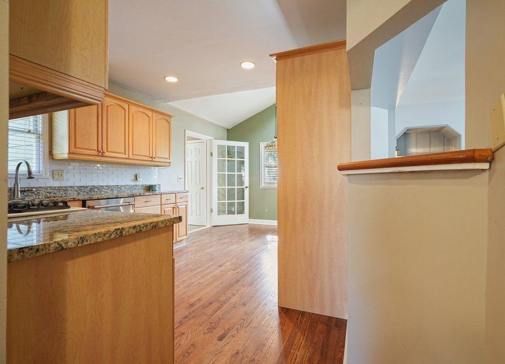 3799 Oglesby Road Powder Springs, GA 30127 - Photo 23 of 39 a kitchen with a wooden floor and a refrigerator