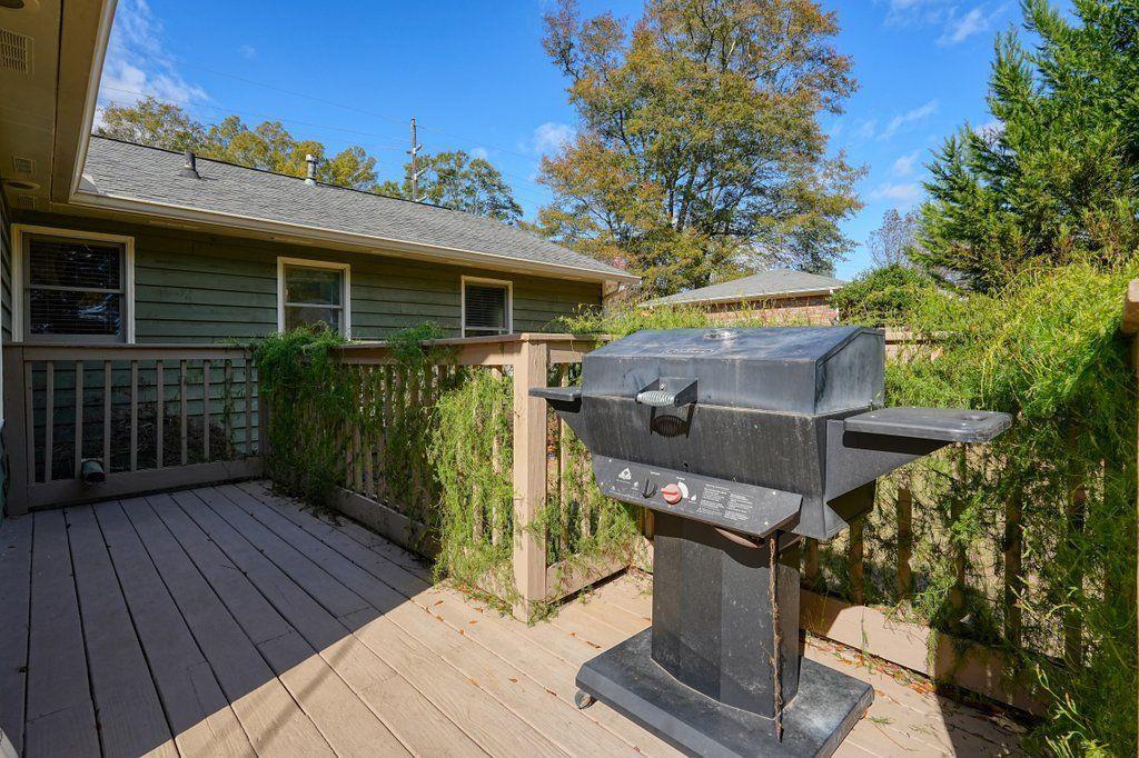 3799 Oglesby Road Powder Springs, GA 30127 - Photo 31 of 39 a view of a patio with table and chairs with wooden floor and fence