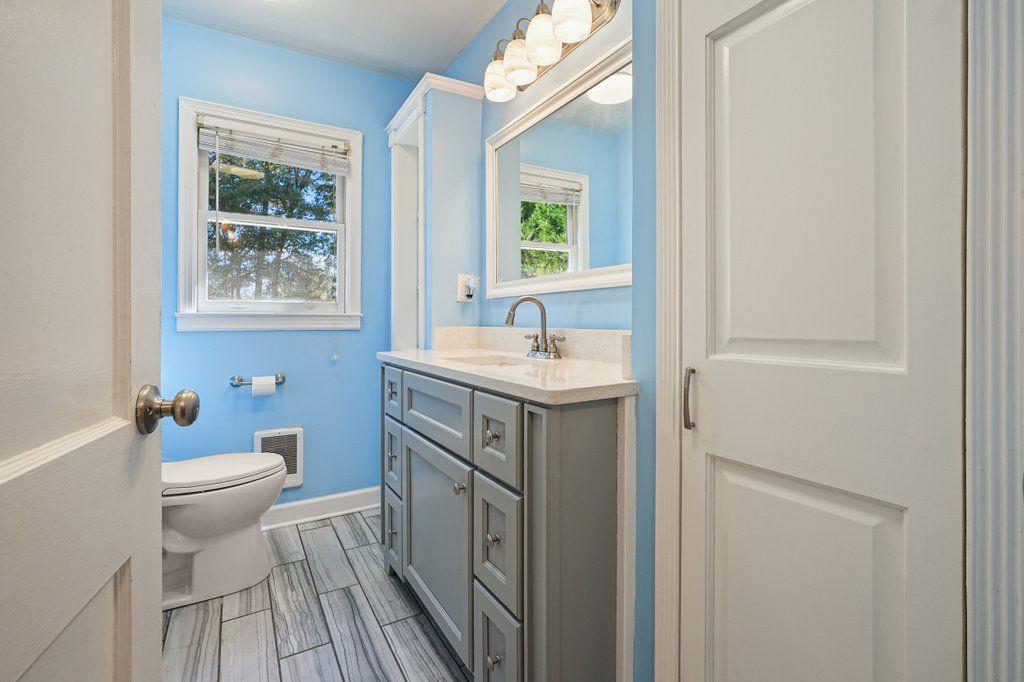 3799 Oglesby Road Powder Springs, GA 30127 - Photo 33 of 39 a bathroom with a sink toilet and window