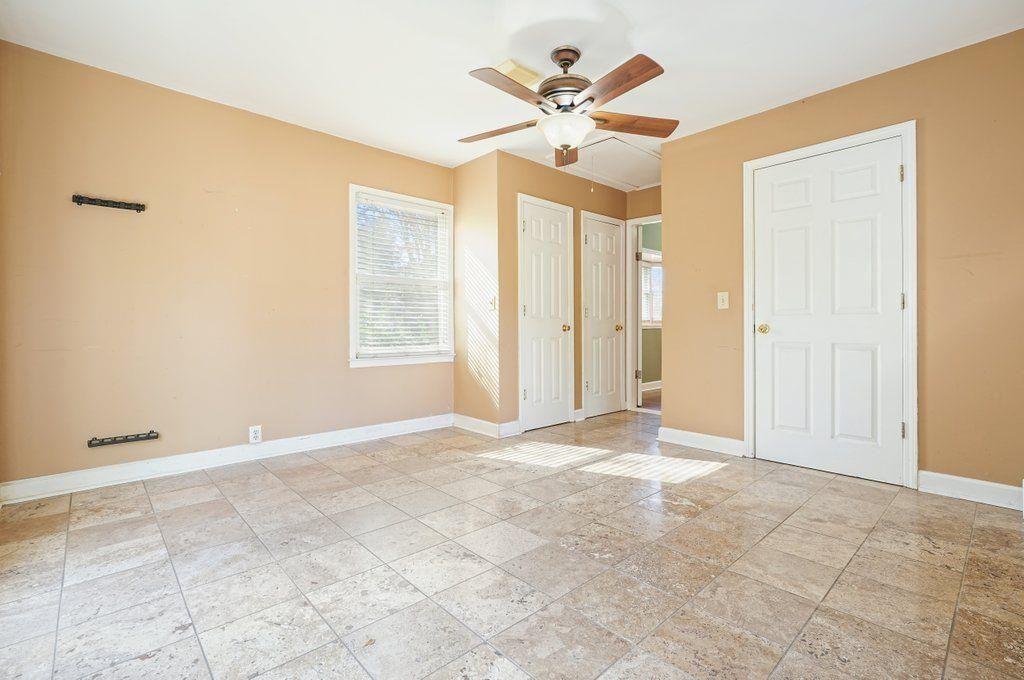 3799 Oglesby Road Powder Springs, GA 30127 - Photo 5 of 39 an empty room with chandelier fan and windows