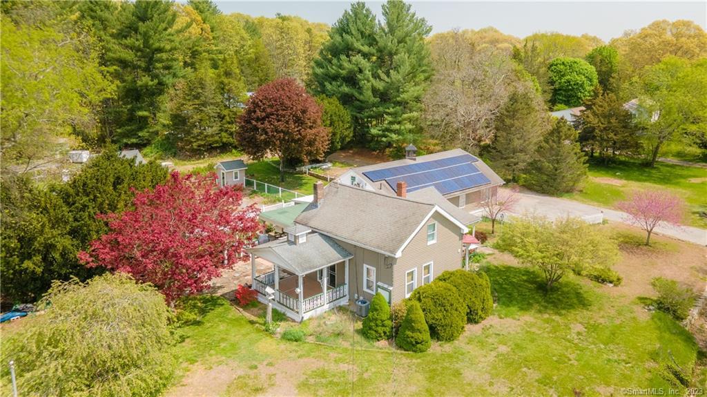 an aerial view of a house with a yard swimming pool and outdoor seating