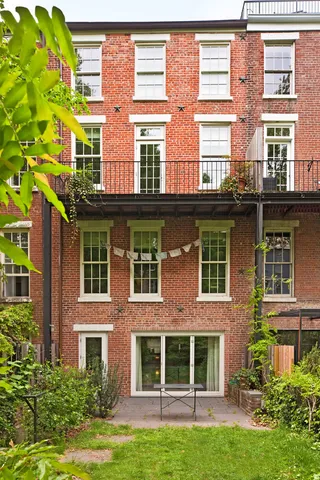 a view of a living room and kitchen with furniture wooden floor