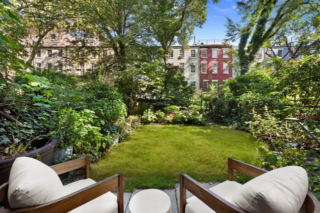 a living room with furniture and floor to ceiling windows