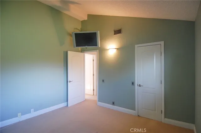 a view of a livingroom with wooden floor and a flat screen tv