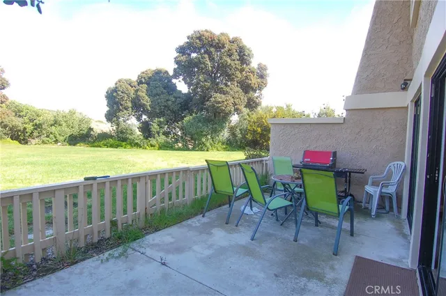 a view of a patio with furniture and garden
