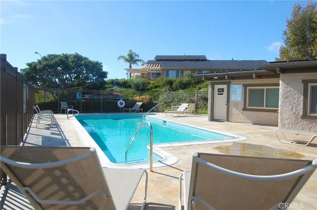 a swimming pool with outdoor seating and yard