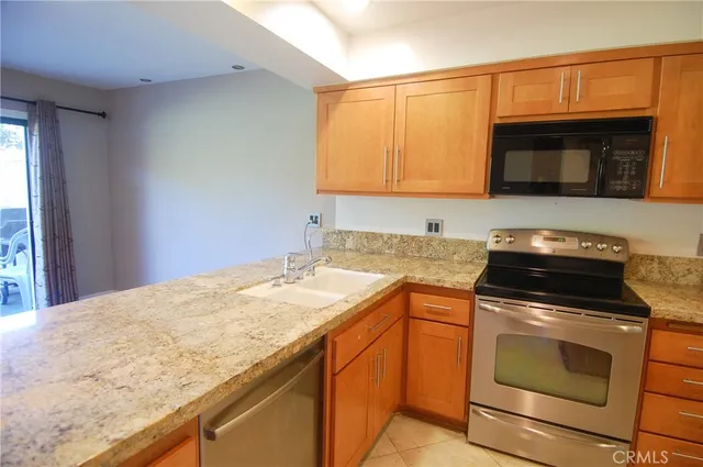 a kitchen with granite countertop a sink and cabinets