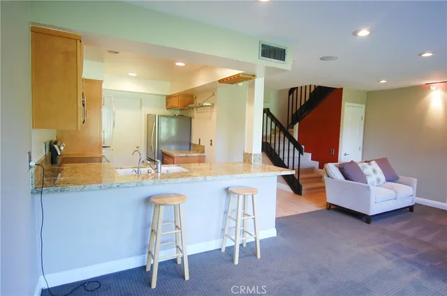 a kitchen with a sink and a refrigerator