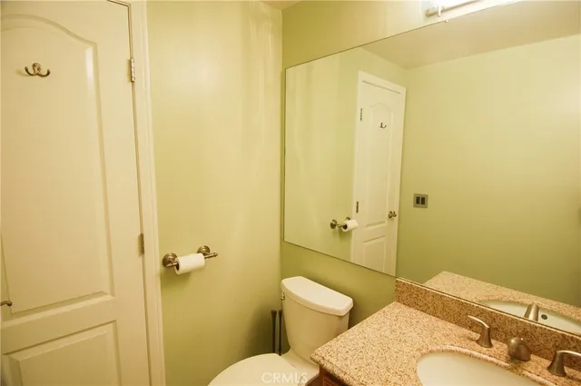a bathroom with a sink and mirror with toilet