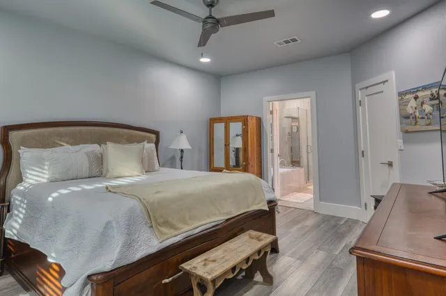 a bedroom with a bed and wooden floor