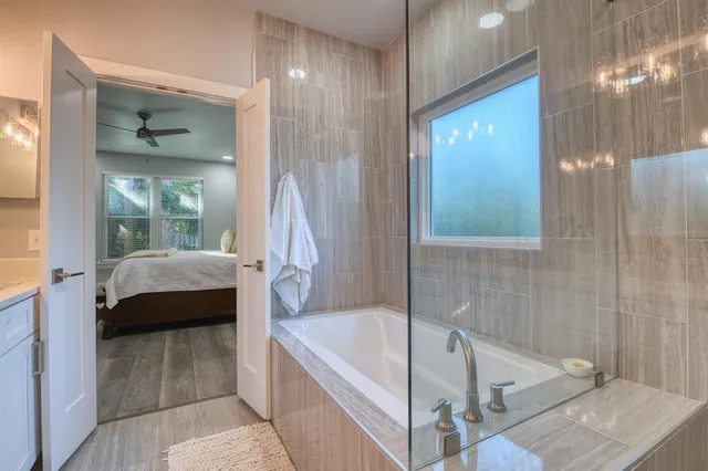 a bathroom with a tub a sink and a shower