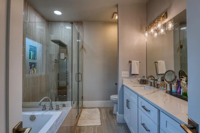 a bathroom with a double vanity sink a mirror and a shower