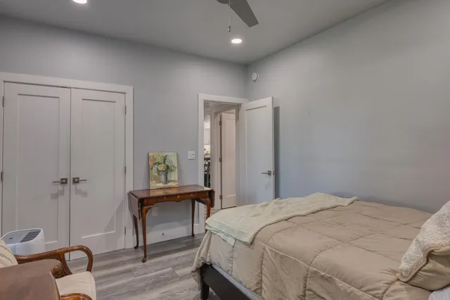 a bedroom with a bed and a lounge chair