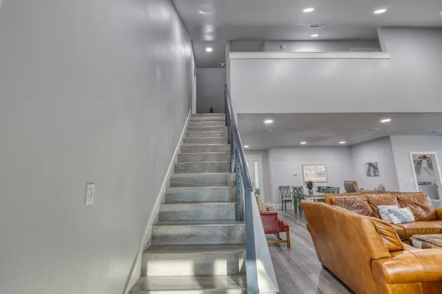 a living room with furniture and stairs
