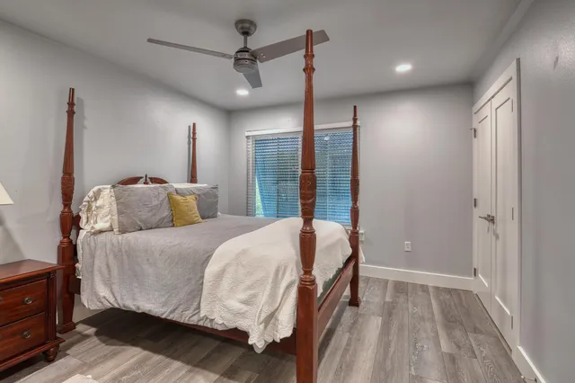 a bedroom with a large bed and a chandelier