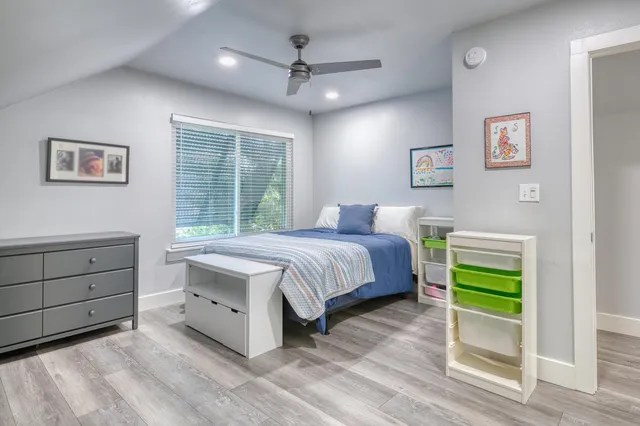 a spacious bedroom with a bed and a window