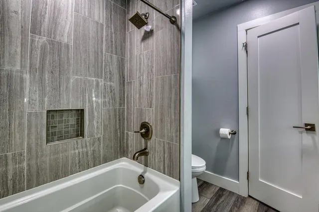 a bathroom with a bathtub a toilet and a shower