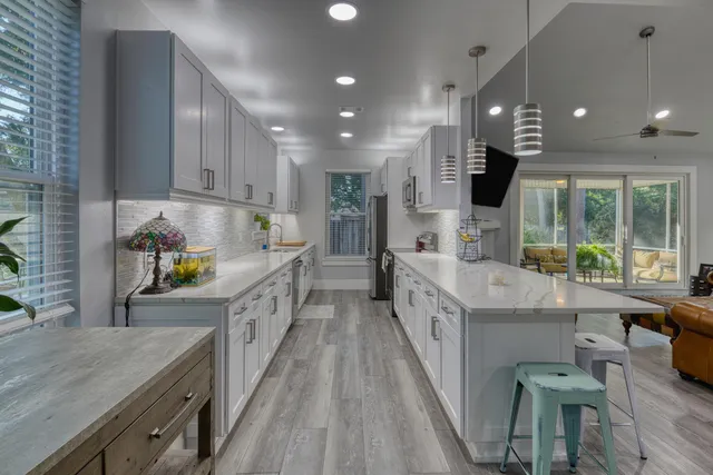 a kitchen with stainless steel appliances sink stove and cabinets