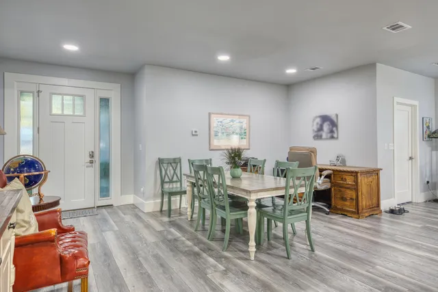 a view of a dining room with furniture and wooden floor