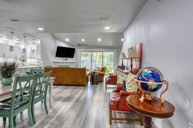 a living room with furniture and wooden floor