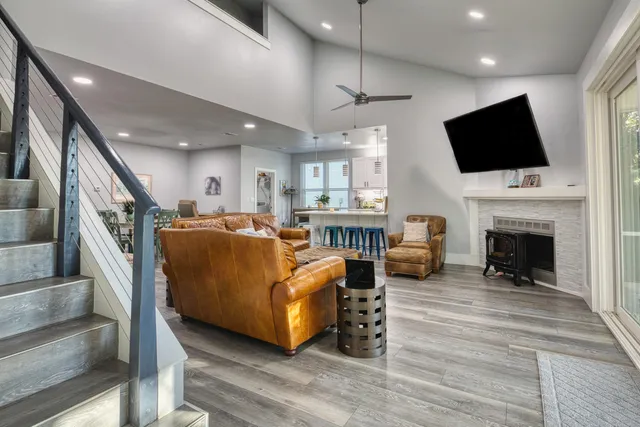 a living room with furniture fireplace and flat screen tv
