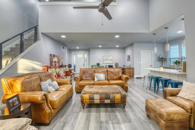 a living room with furniture and a wooden floor