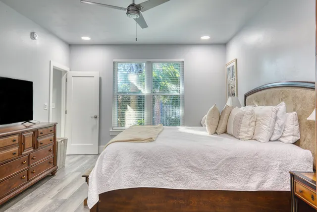 a bedroom with a large bed and a flat screen tv