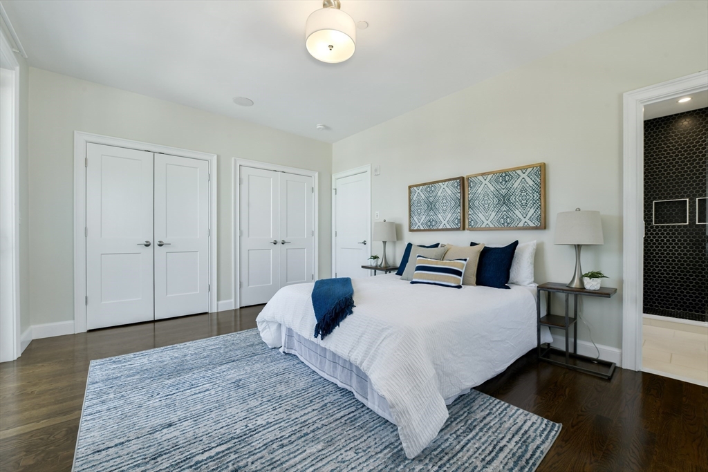 884 Adams Street, Unit 3 Boston, MA 02124 - Photo 13 of 24 a bedroom with bed and a night stand