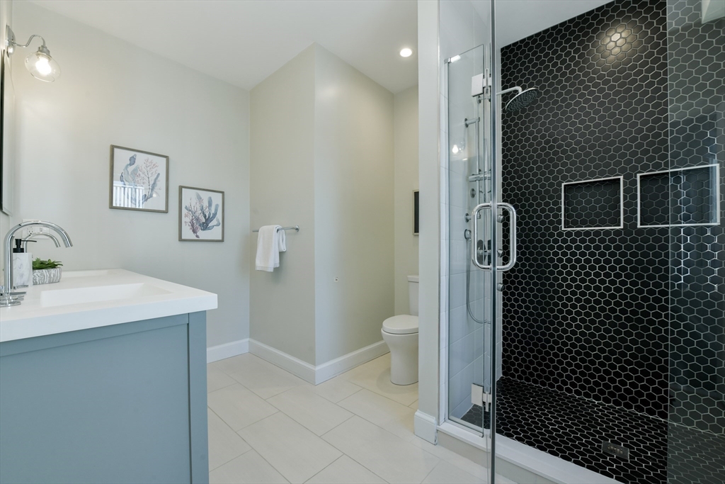 884 Adams Street, Unit 3 Boston, MA 02124 - Photo 14 of 24 a bathroom with a sink toilet and shower