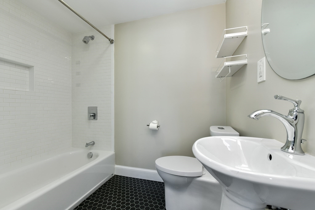 884 Adams Street, Unit 3 Boston, MA 02124 - Photo 19 of 24 a bathroom with a sink a toilet and shower