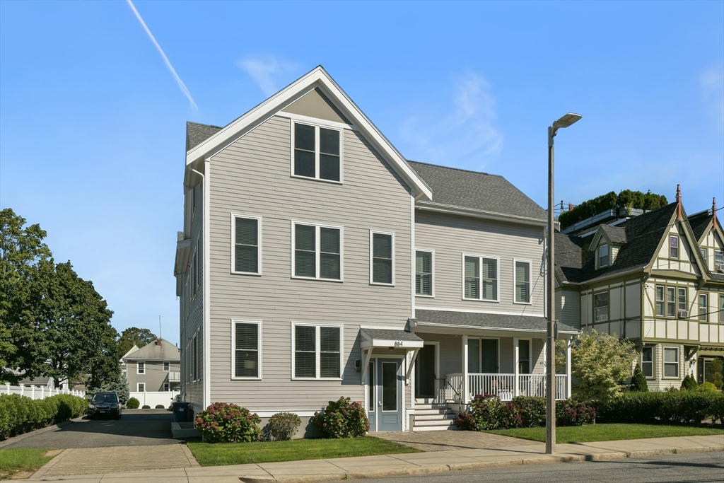 884 Adams Street, Unit 3 Boston, MA 02124 - Photo 23 of 24 a front view of a house with a yard