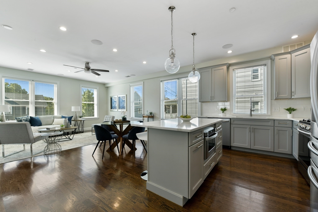 884 Adams Street, Unit 3 Boston, MA 02124 - Photo 5 of 24 a kitchen with sink cabinets and wooden floor