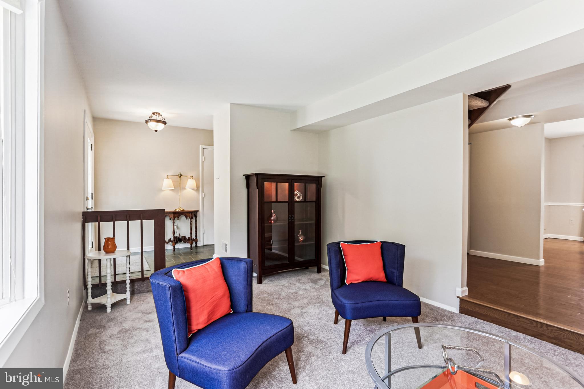 9013 2nd Avenue Silver Spring, MD 20910 - Photo 11 of 56 a blue chair sitting in a living room next to a chair