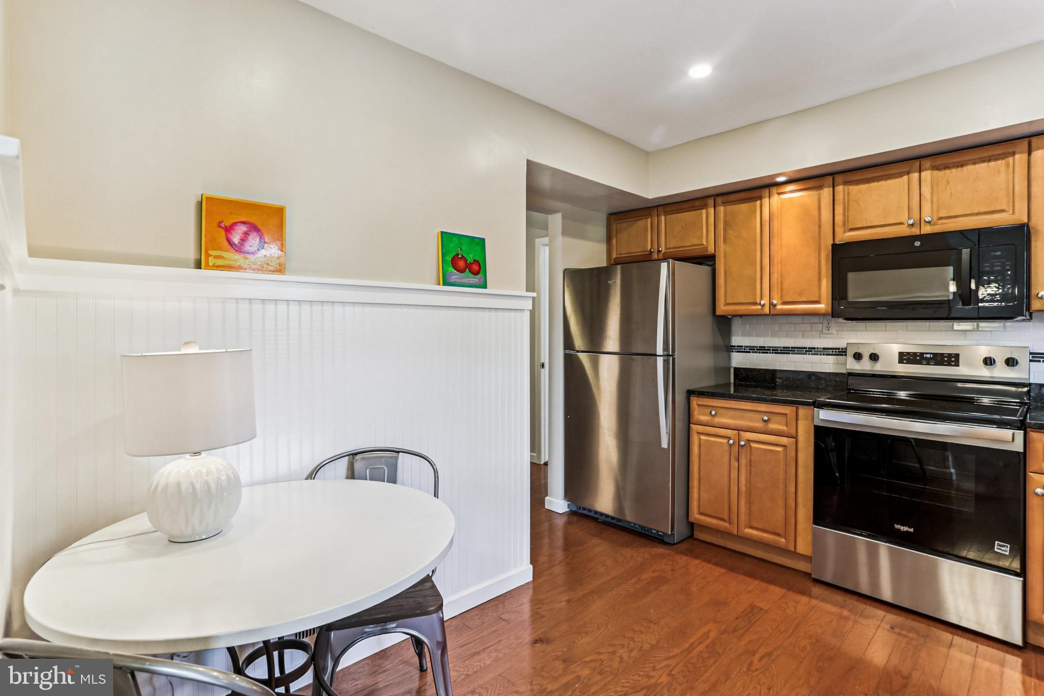 9013 2nd Avenue Silver Spring, MD 20910 - Photo 14 of 56 a kitchen with stainless steel appliances granite countertop a refrigerator a stove a sink and a microwave