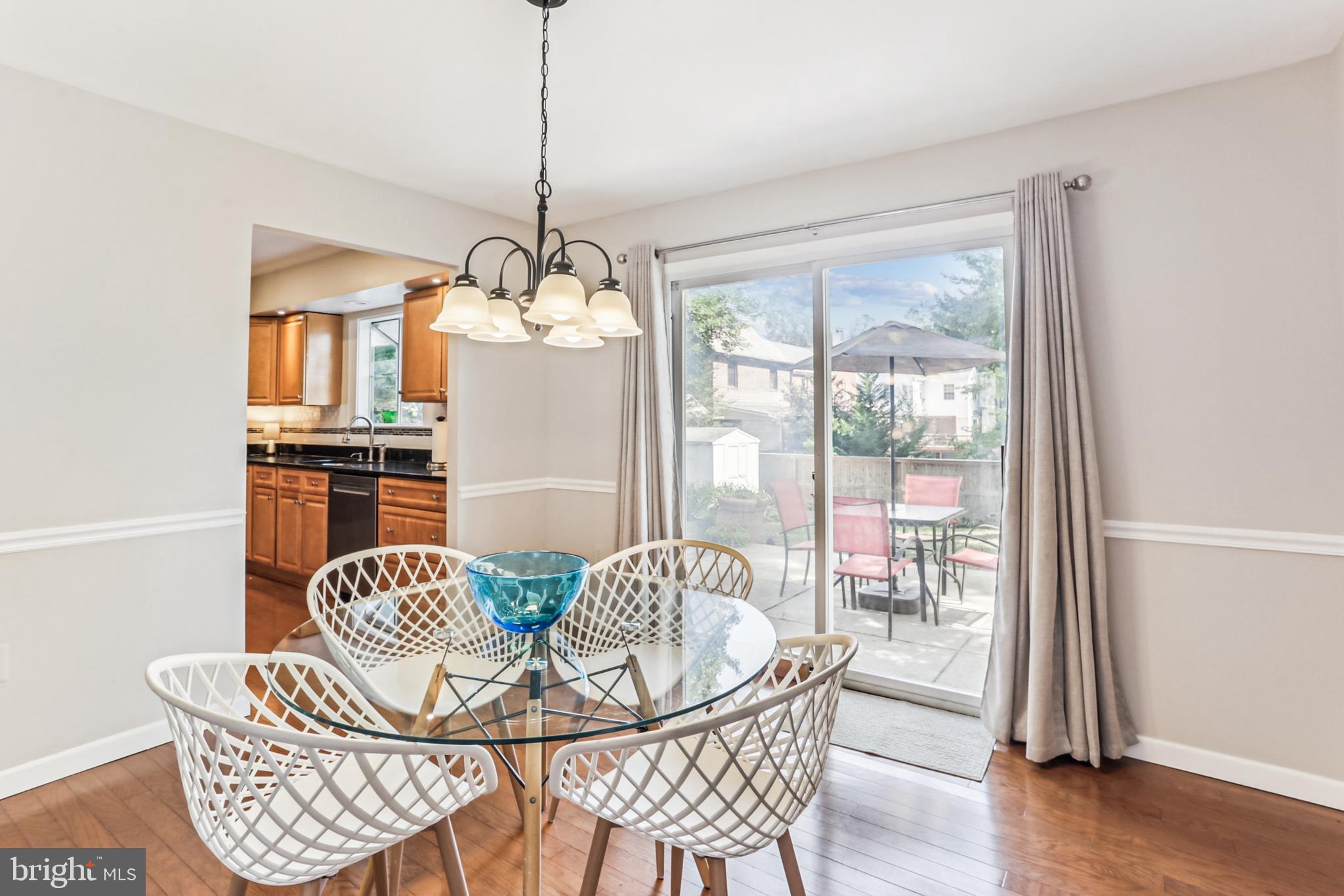 9013 2nd Avenue Silver Spring, MD 20910 - Photo 17 of 56 a dining room with furniture a chandelier and wooden floor