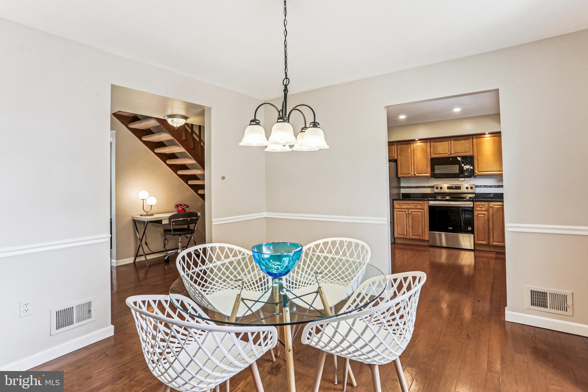 9013 2nd Avenue Silver Spring, MD 20910 - Photo 18 of 56 a dining room with furniture a chandelier and wooden floor