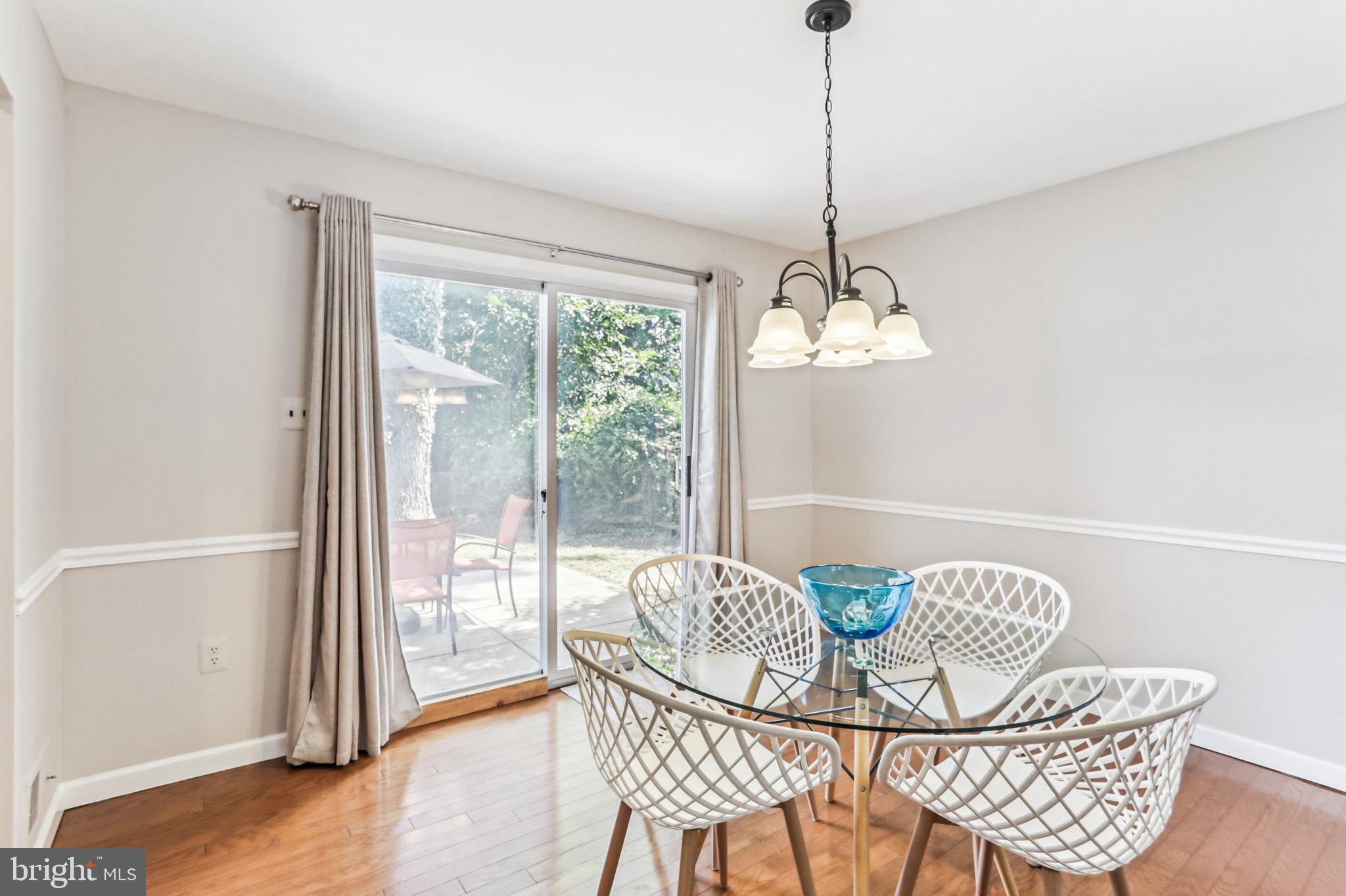 9013 2nd Avenue Silver Spring, MD 20910 - Photo 19 of 56 a dining room with furniture a window and a chandelier
