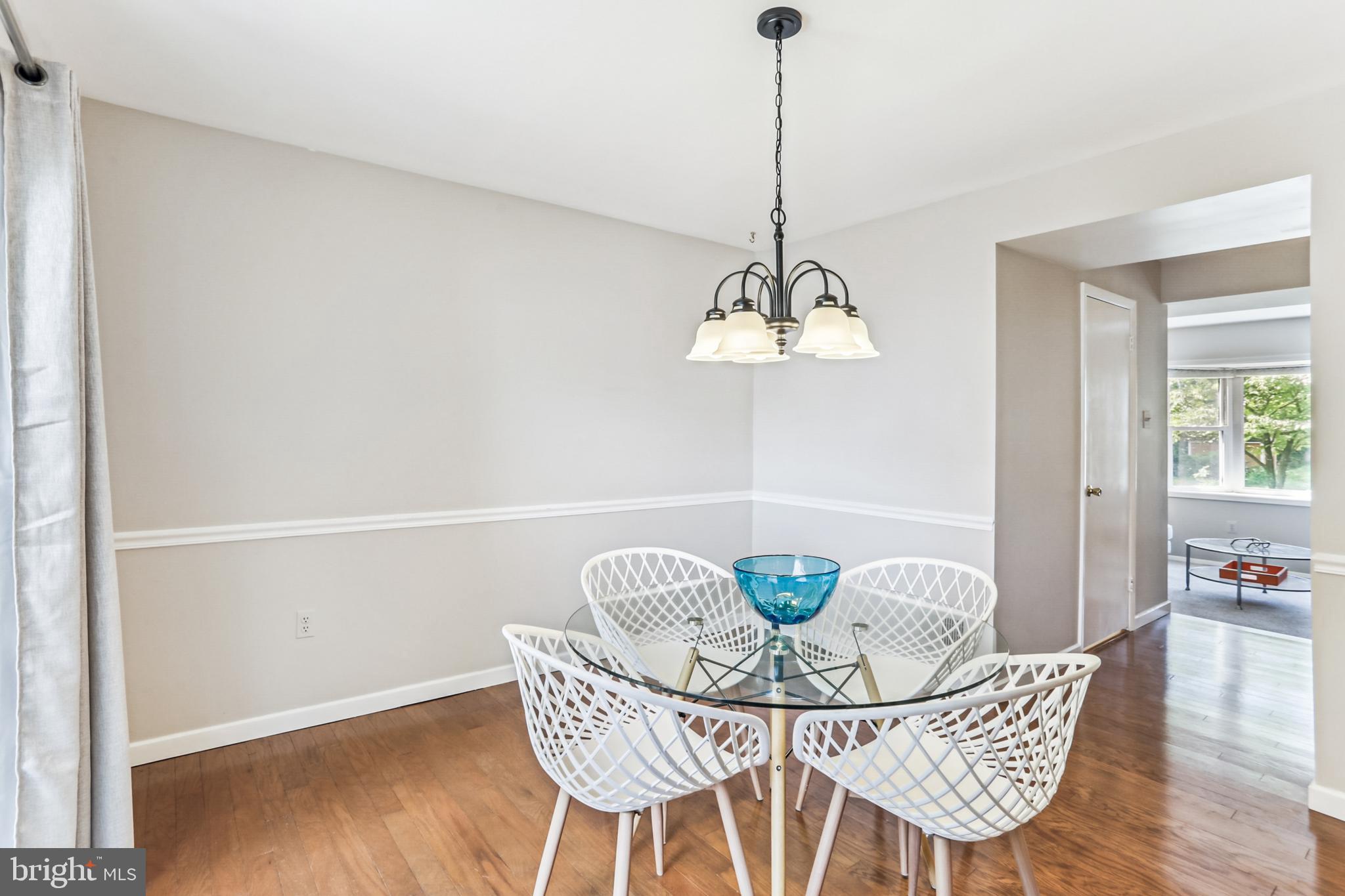 9013 2nd Avenue Silver Spring, MD 20910 - Photo 20 of 56 a view of a dining room with furniture wooden floor and a chandelier