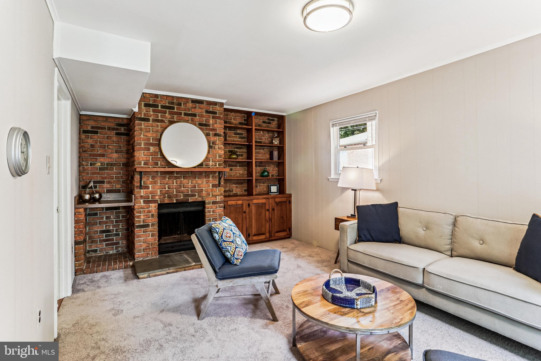 9013 2nd Avenue Silver Spring, MD 20910 - Photo 24 of 56 a living room with furniture a fireplace and a flat screen tv