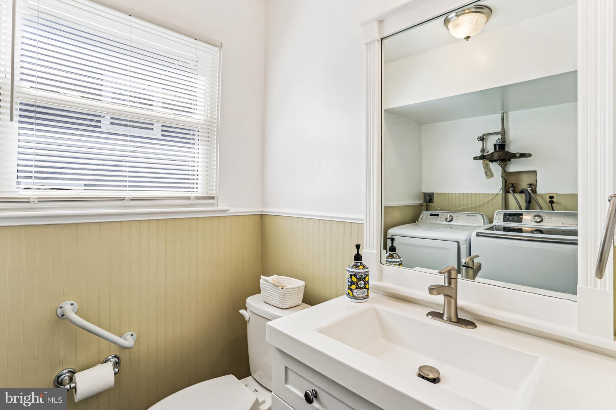 9013 2nd Avenue Silver Spring, MD 20910 - Photo 25 of 56 a bathroom with a sink a toilet and mirror