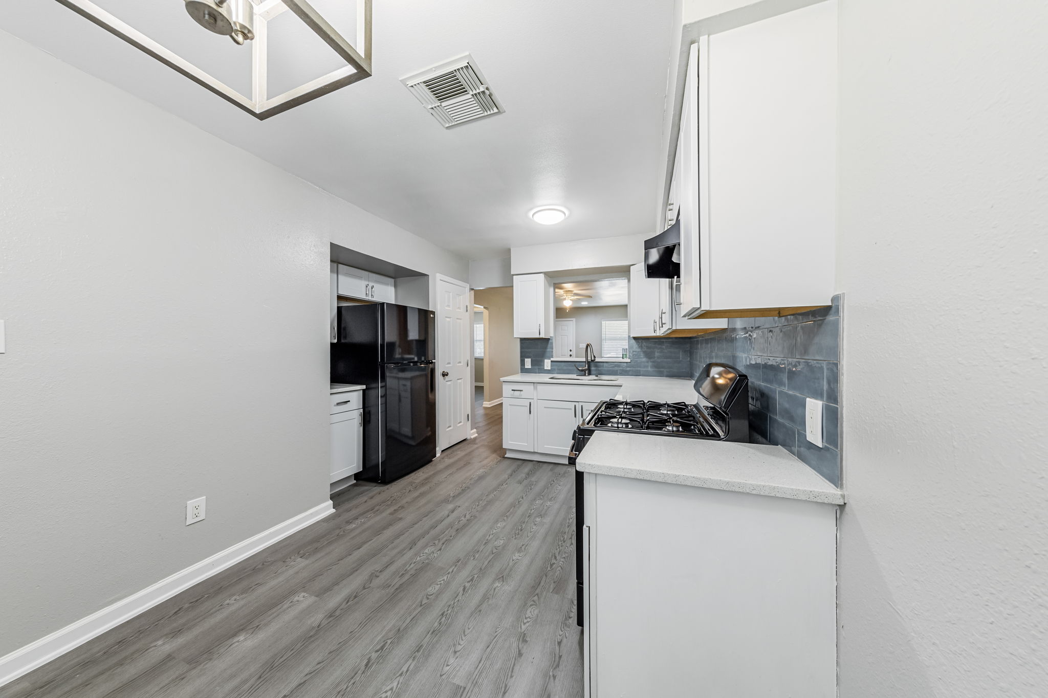 2011 East Stassney Lane, Unit A Austin, TX 78744 - Photo 11 of 23 a kitchen with a stove a refrigerator and a sink