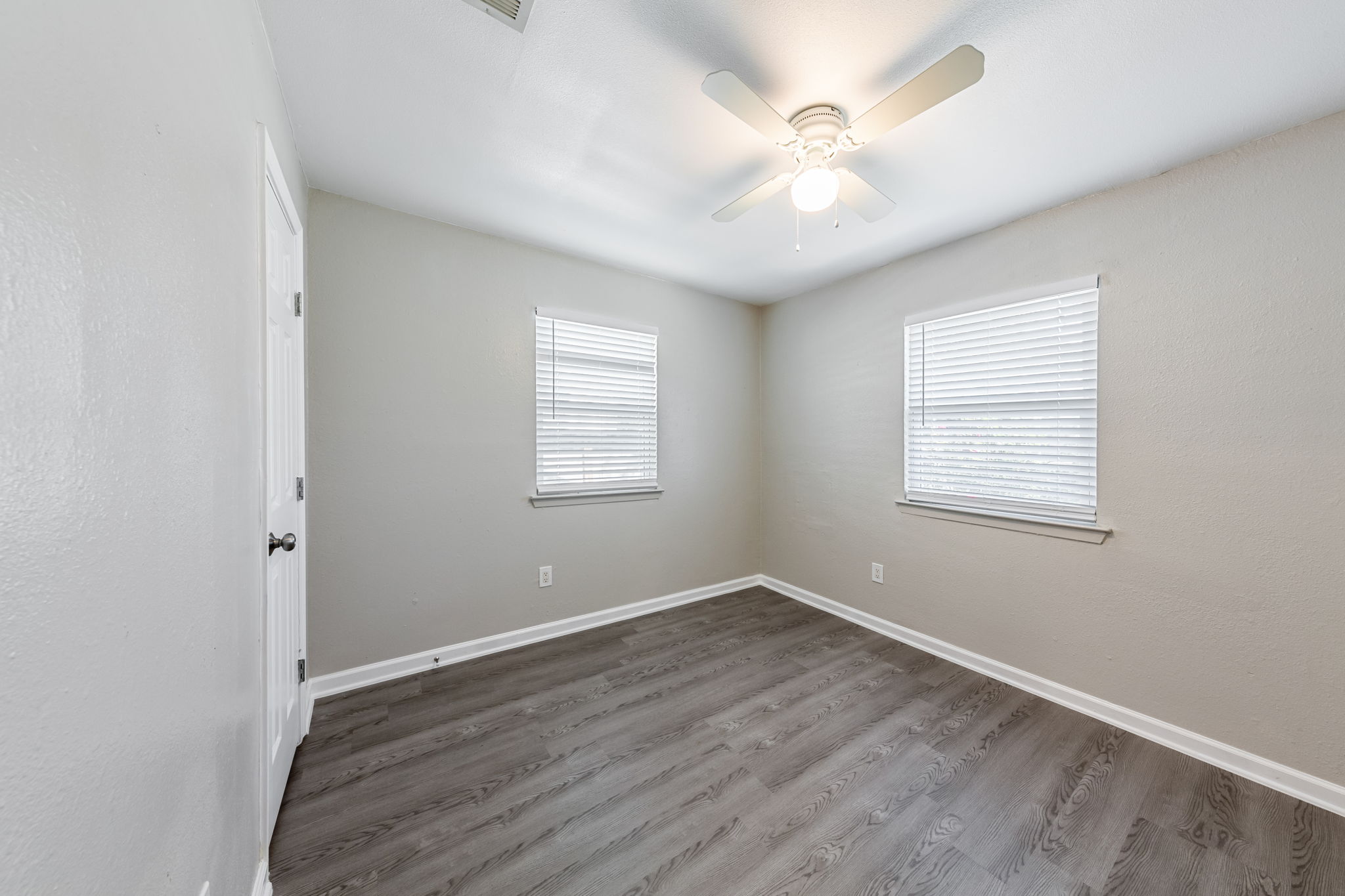 2011 East Stassney Lane, Unit A Austin, TX 78744 - Photo 12 of 23 an empty room with wooden floor and windows