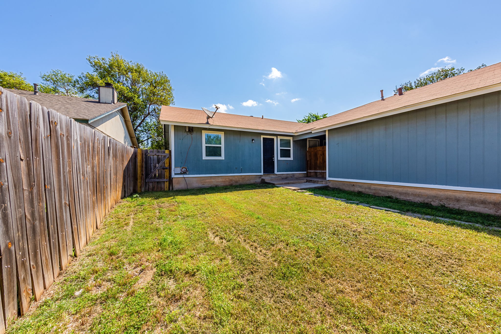 2011 East Stassney Lane, Unit A Austin, TX 78744 - Photo 22 of 23 a view of a house with a backyard and a garden