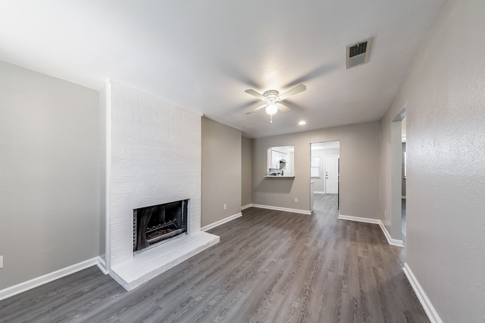 2011 East Stassney Lane, Unit A Austin, TX 78744 - Photo 4 of 23 an empty room with wooden floor and fireplace