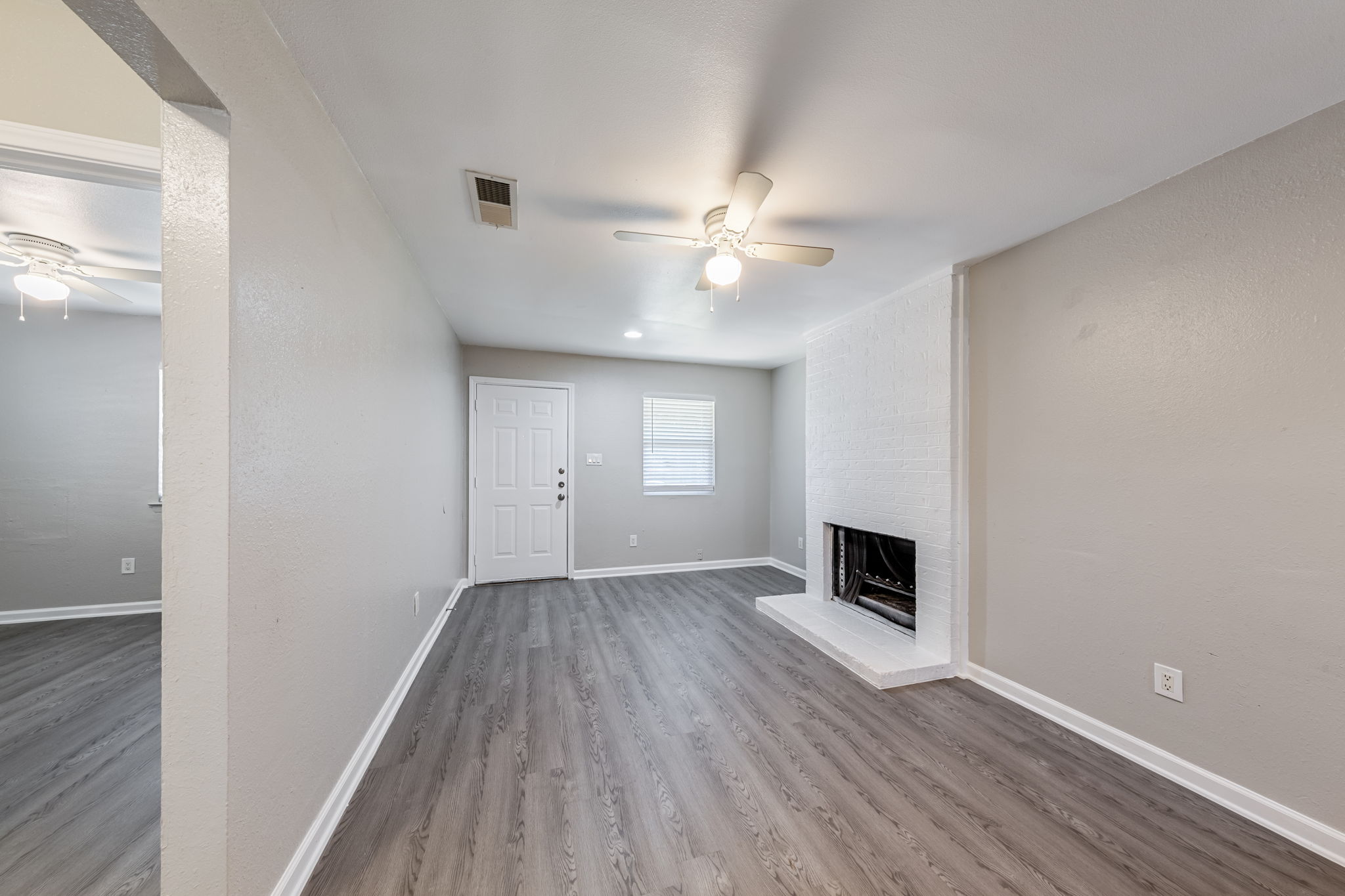 2011 East Stassney Lane, Unit A Austin, TX 78744 - Photo 5 of 23 wooden floor in an empty room with a fireplace
