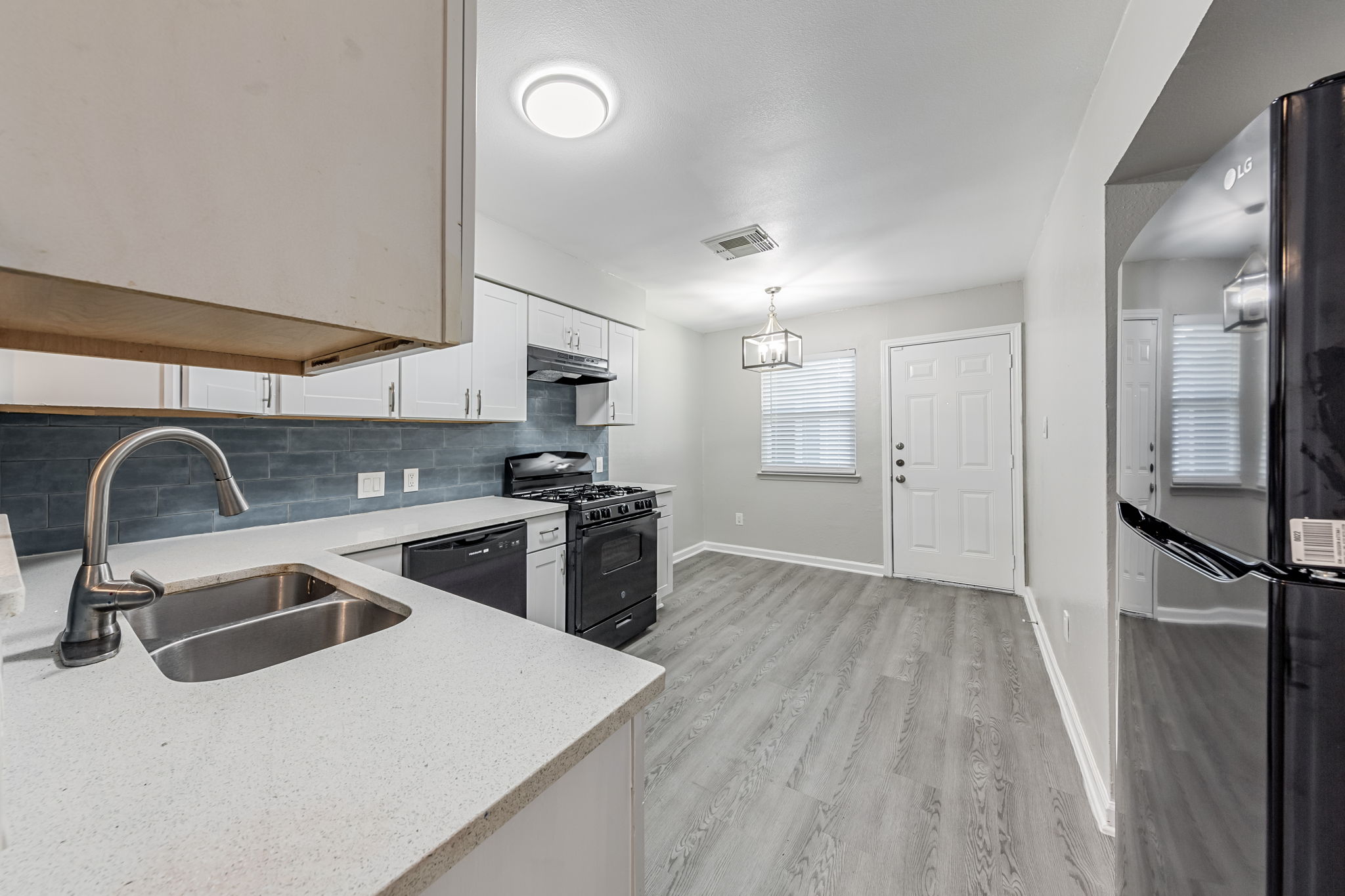 2011 East Stassney Lane, Unit A Austin, TX 78744 - Photo 7 of 23 a kitchen with stainless steel appliances a sink a stove and refrigerator
