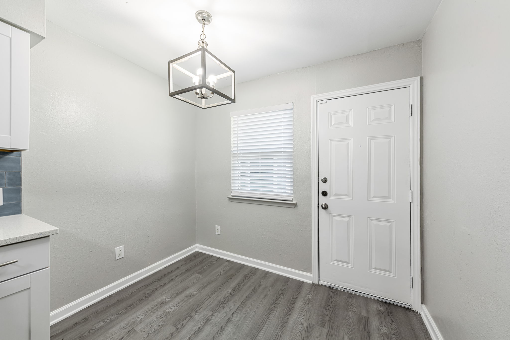 2011 East Stassney Lane, Unit A Austin, TX 78744 - Photo 10 of 23 wooden floor in an empty room with a window