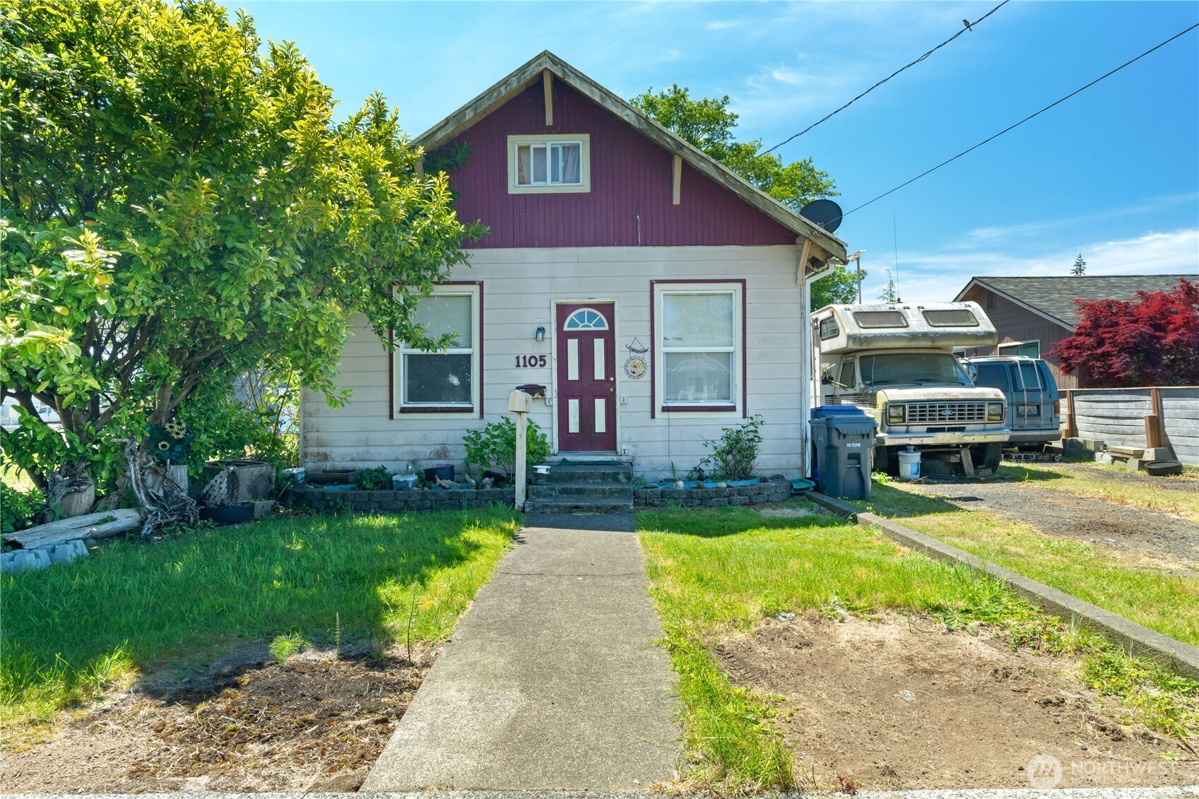 1105 West Perry Street Aberdeen, WA 98520 - Photo 1 of 20 a front view of a house with a garden and yard