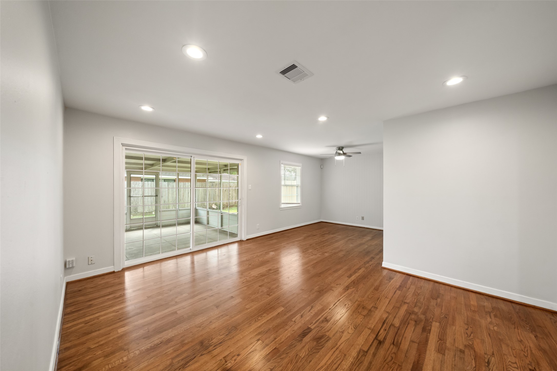 9779 Westview Drive Houston, TX 77055 - Photo 14 of 27 an empty room with wooden floor and windows